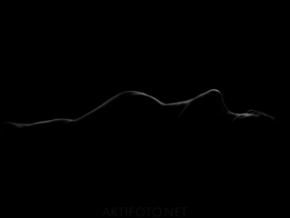 Kunstiline ilus aktifoto naise alasti kehast tumedate toonidega
